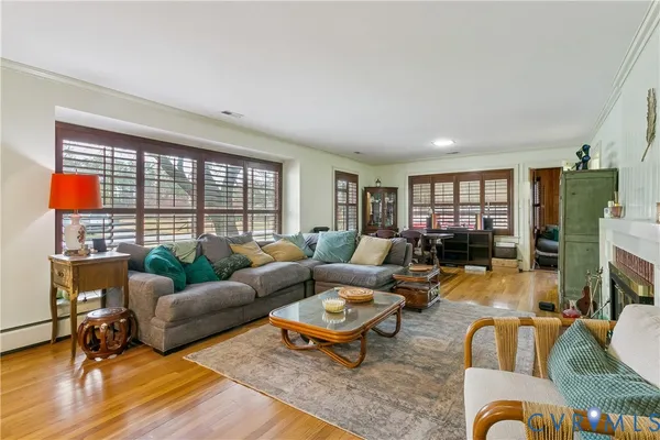 a living room with furniture and a floor to ceiling window
