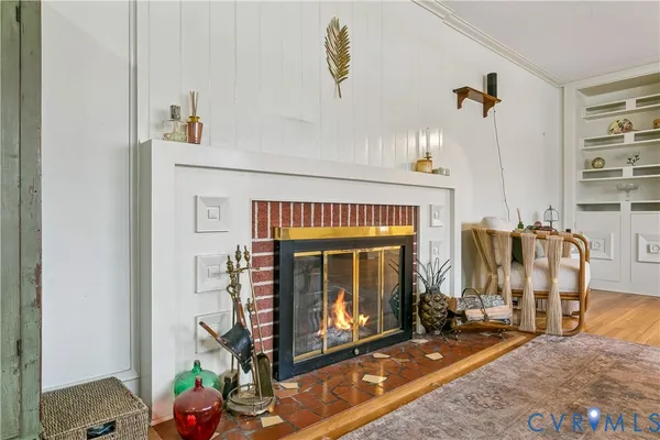 a living room with fireplace furniture and a window