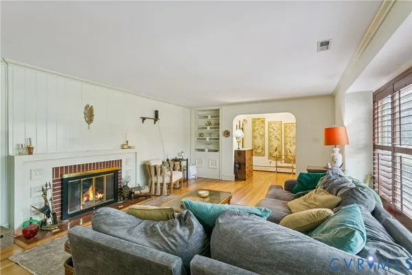 a living room with furniture and a fireplace