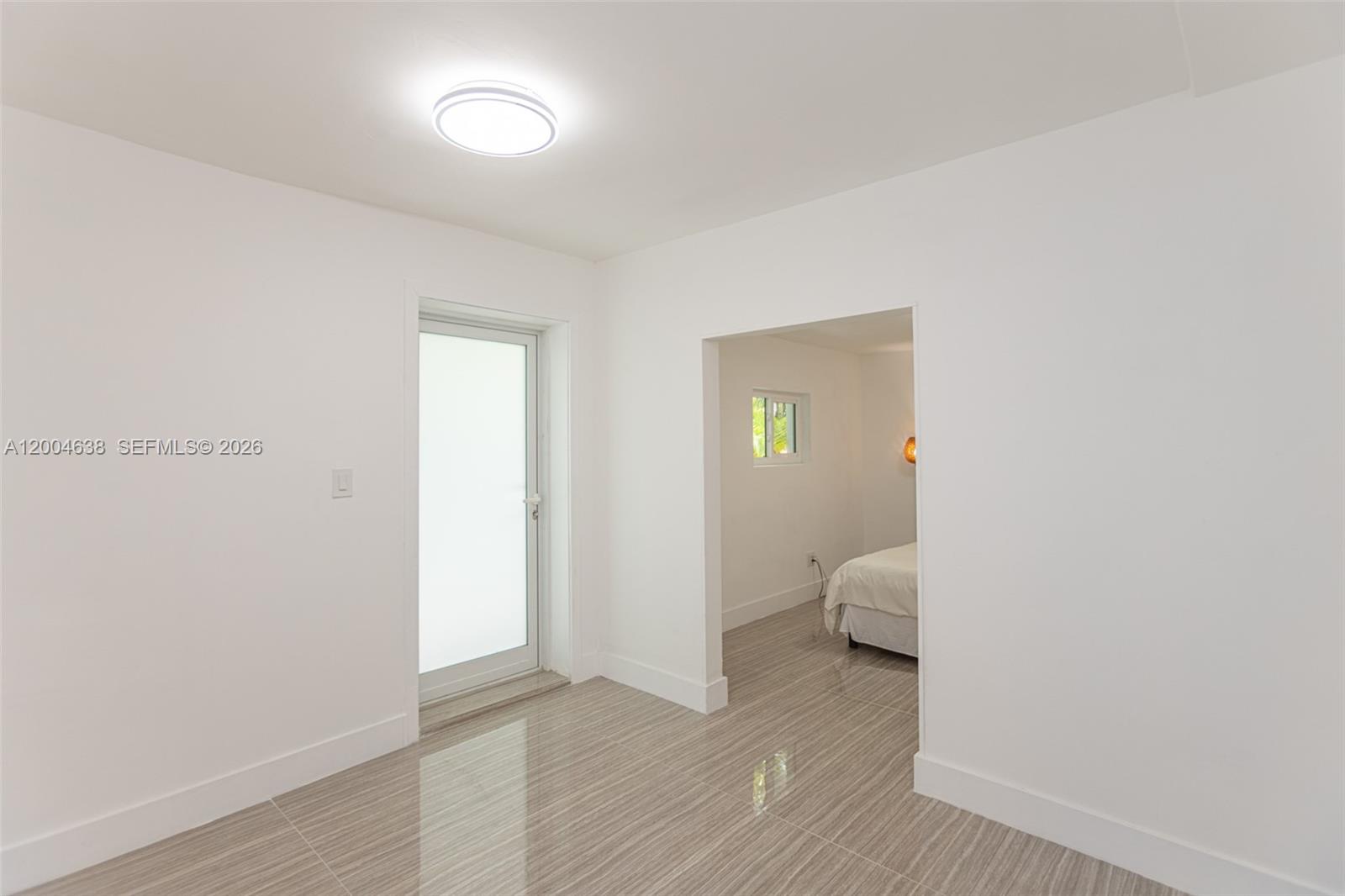 1690 Daytonia Road Miami Beach, FL 33141 - Photo 77 of 88 a view of a room with wooden floor and a bathroom