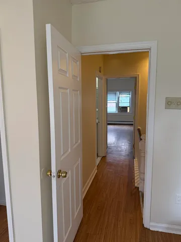 a view of hallway with wooden floor