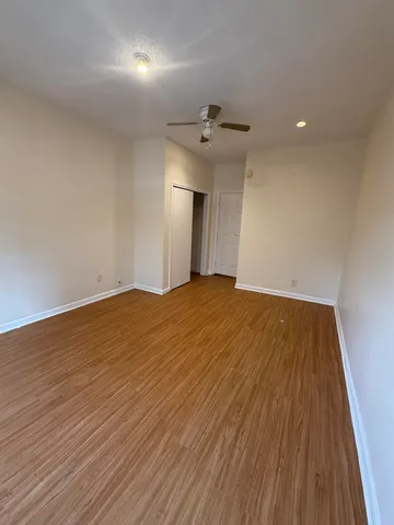 a view of empty room with wooden floor