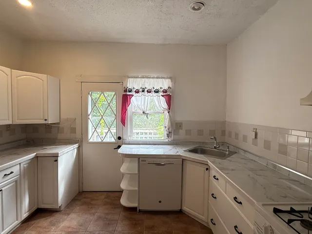 a kitchen with a sink stove and cabinets