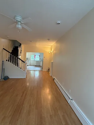 a view of a room with wooden floor