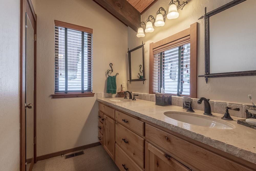 1380 Pine Trail Alpine Meadows, CA 96146 - Photo 17 of 21 a bathroom with a granite countertop sink mirror and window