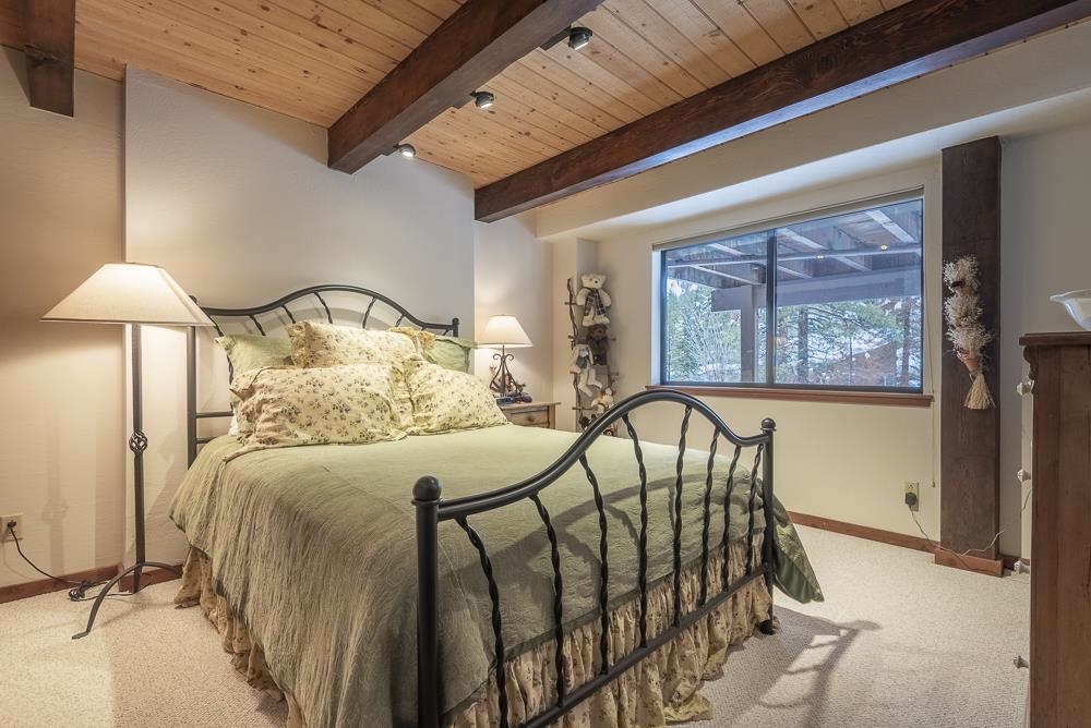 1380 Pine Trail Alpine Meadows, CA 96146 - Photo 18 of 21 a bedroom with a bed and a table