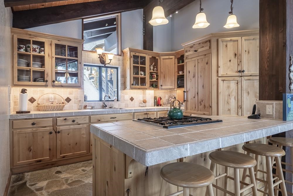 1380 Pine Trail Alpine Meadows, CA 96146 - Photo 9 of 21 a kitchen with a sink stove and wooden cabinets