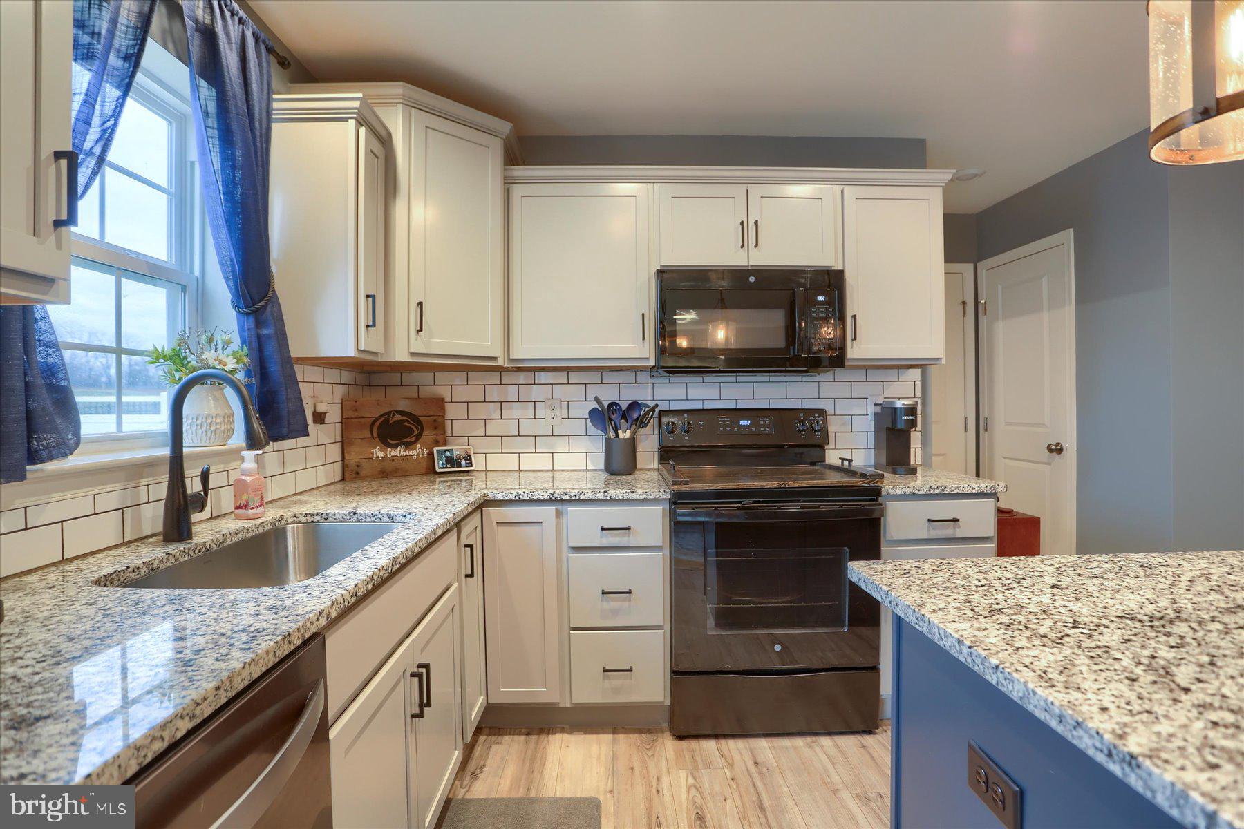 3480 Winter Drive Dover, PA 17315 - Photo 14 of 39 a kitchen with kitchen island granite countertop a sink stove and cabinets