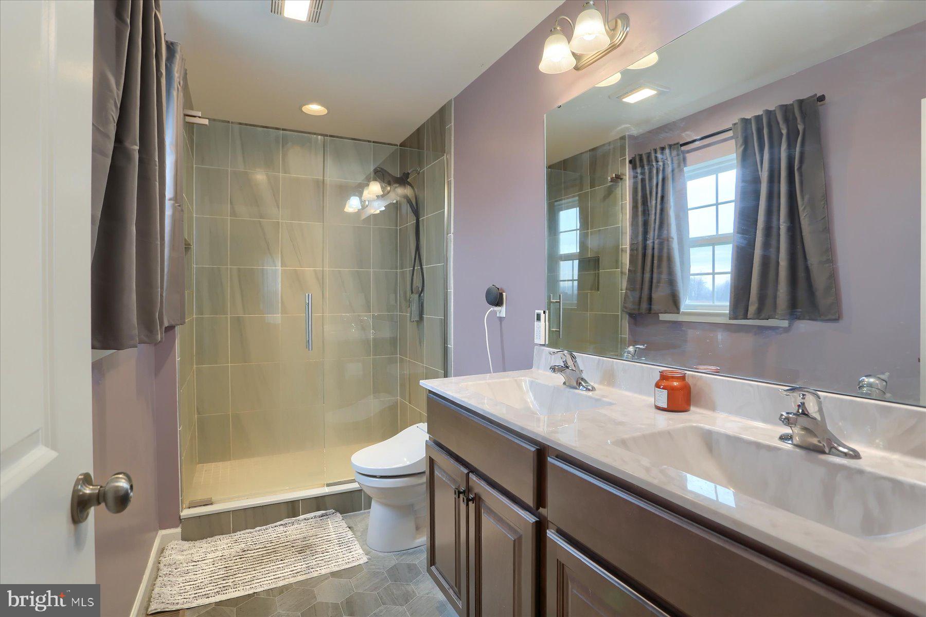 3480 Winter Drive Dover, PA 17315 - Photo 31 of 39 a bathroom with a double vanity sink toilet mirror and shower