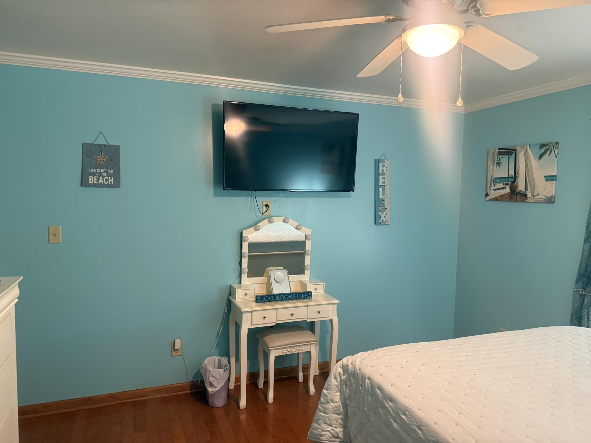 4532 Kassell Road Memphis, TN 38116 - Photo 26 of 39 Wood-finish flooring with crown molding and a ceiling fan with integrated lighting