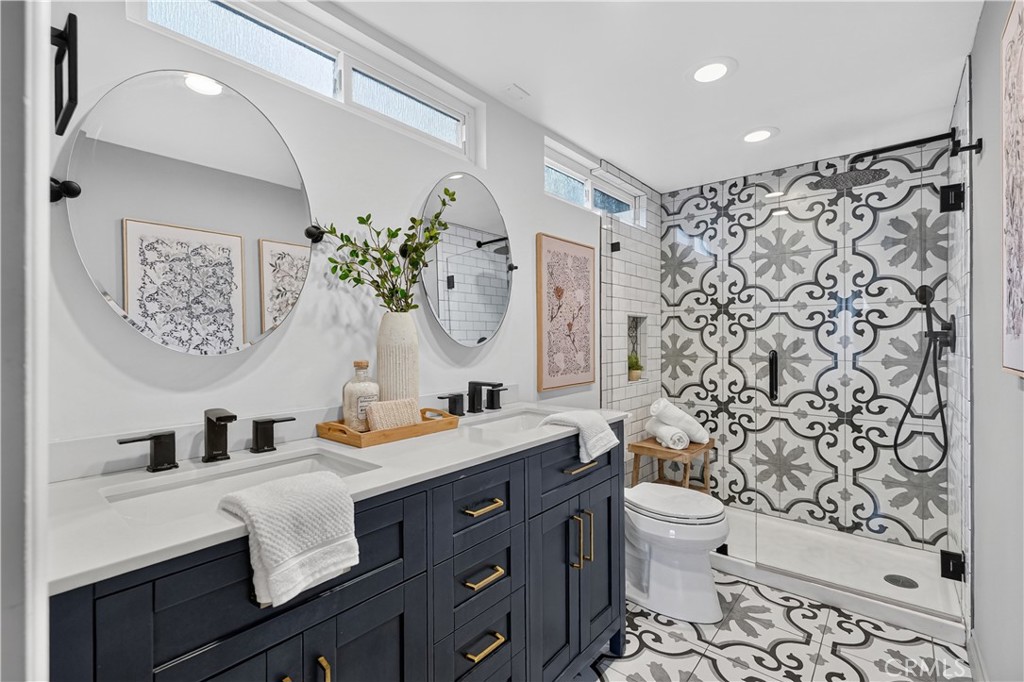 4023 East Ransom Street Long Beach, CA 90804 - Photo 16 of 40 Remodeled bathroom with dual sinks and large walk-in shower.