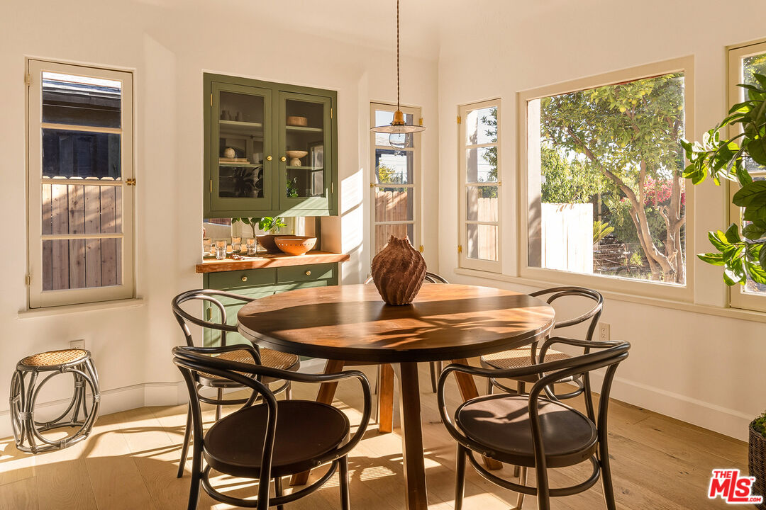 585 Mountain View Street Altadena, CA 91001 - Photo 11 of 31 a dining room with furniture a chandelier and wooden floor