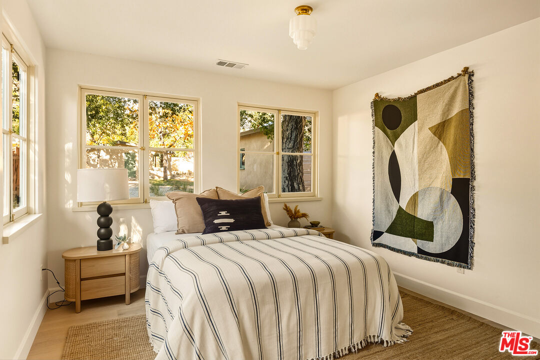 585 Mountain View Street Altadena, CA 91001 - Photo 18 of 31 a bedroom with a bed mirror and window