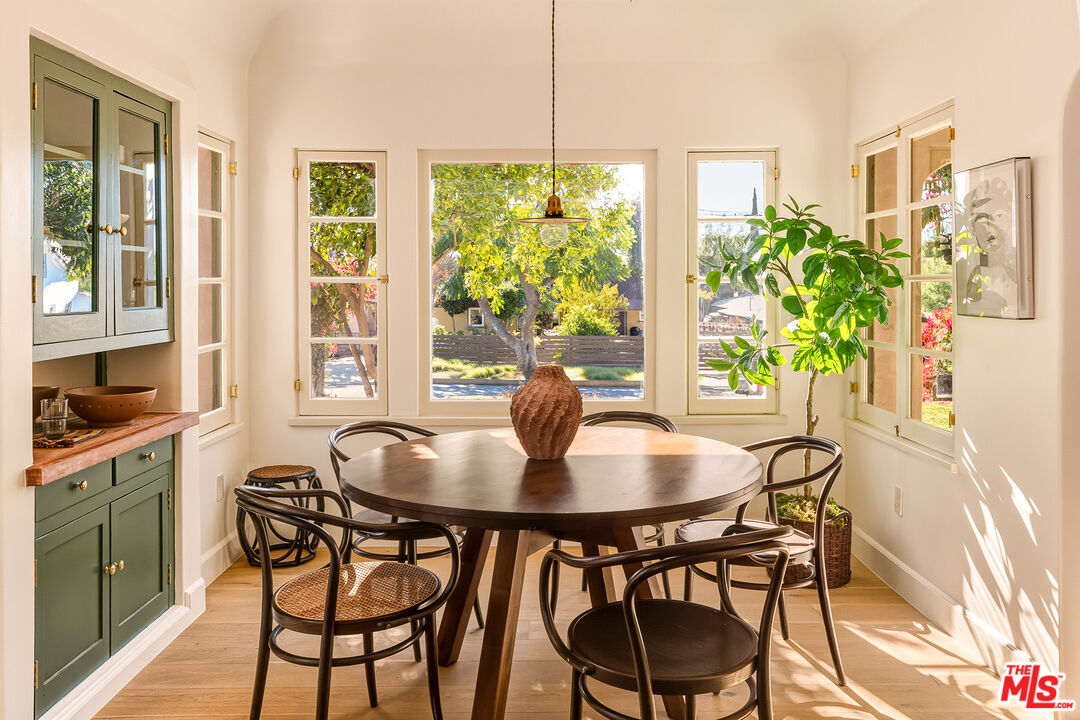 585 Mountain View Street Altadena, CA 91001 - Photo 10 of 31 a dining room with furniture potted plants and wooden floor