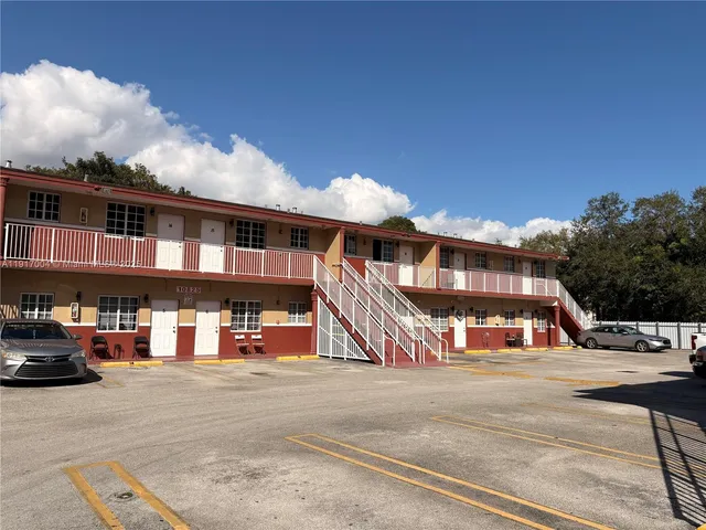 a view of a building with car parked