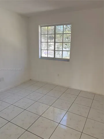 an empty room with white walls
