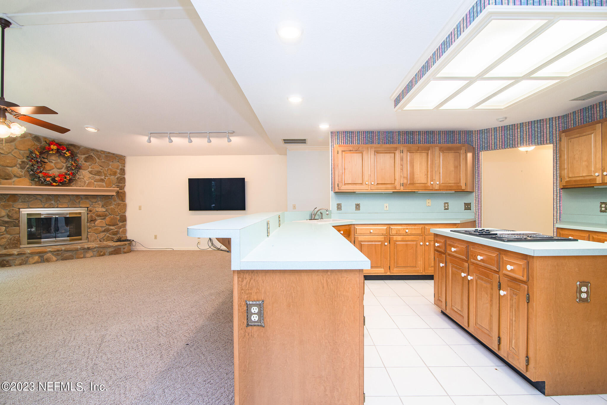 4233 Wicks Branch Road St. Augustine, FL 32086 - Photo 14 of 45 a kitchen with stainless steel appliances kitchen island granite countertop a sink and a stove top oven with wooden floor