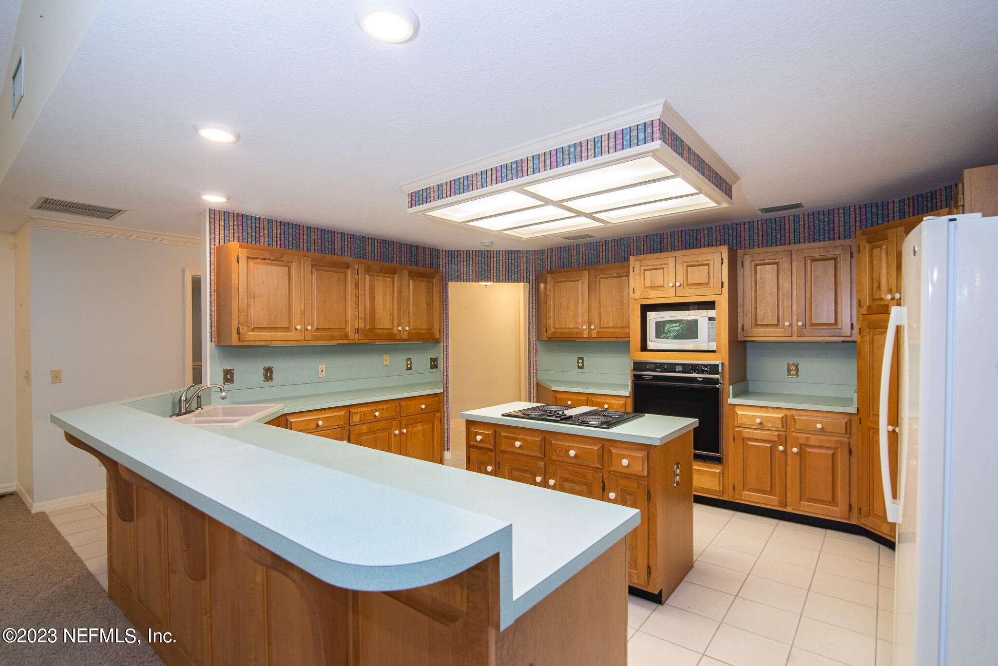 4233 Wicks Branch Road St. Augustine, FL 32086 - Photo 15 of 45 a kitchen with stainless steel appliances granite countertop sink stove and refrigerator