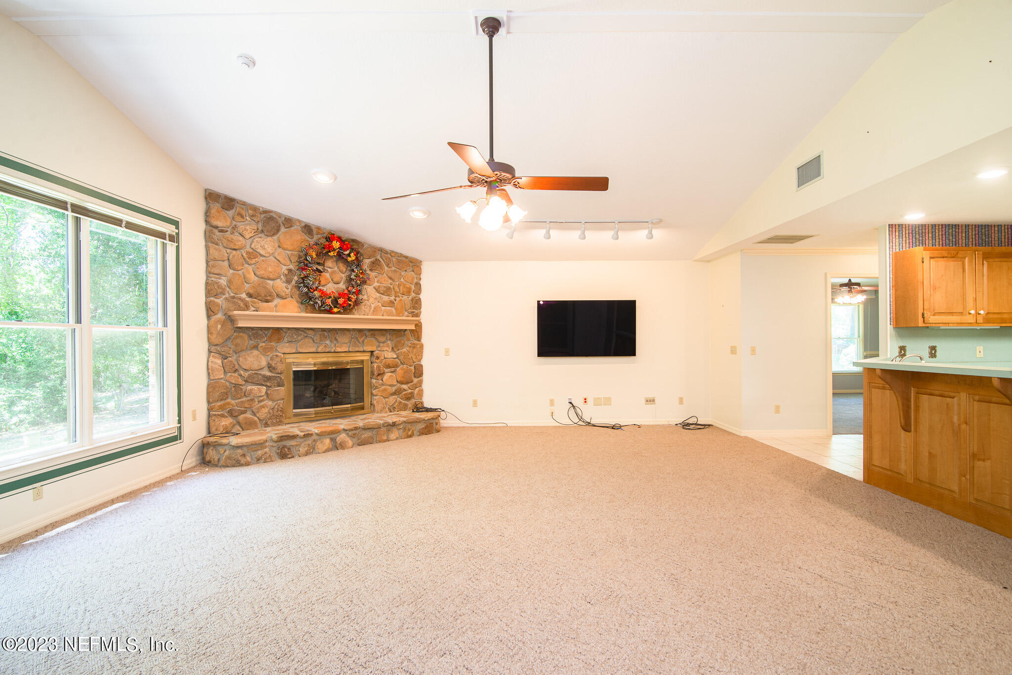 4233 Wicks Branch Road St. Augustine, FL 32086 - Photo 17 of 45 a view of an empty room with a fireplace and a window