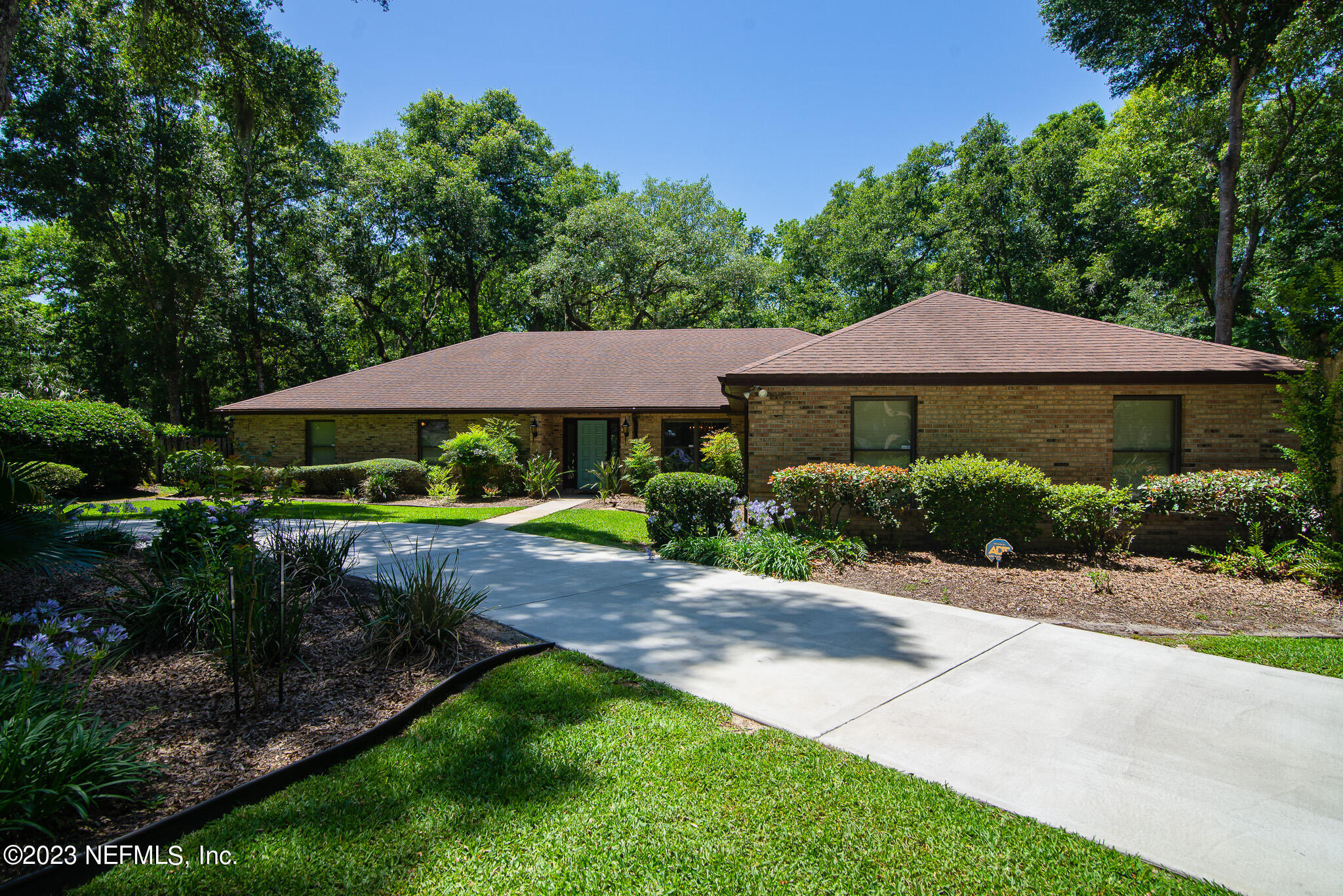 4233 Wicks Branch Road St. Augustine, FL 32086 - Photo 2 of 45 a view of a house with swimming pool and a yard