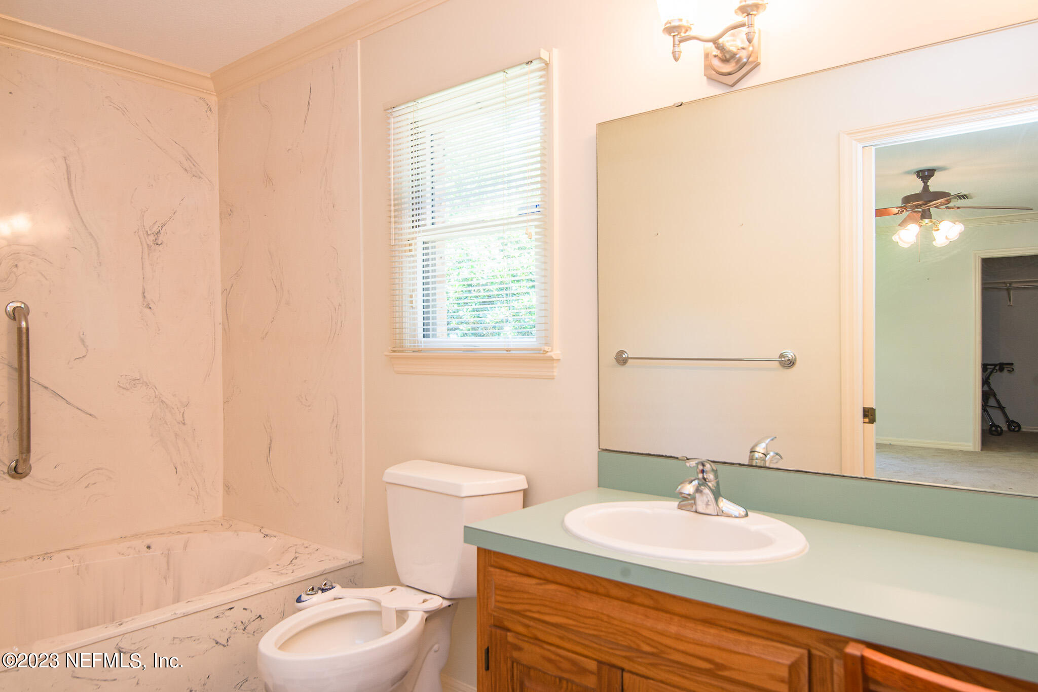 4233 Wicks Branch Road St. Augustine, FL 32086 - Photo 21 of 45 a bathroom with a granite countertop sink toilet and shower