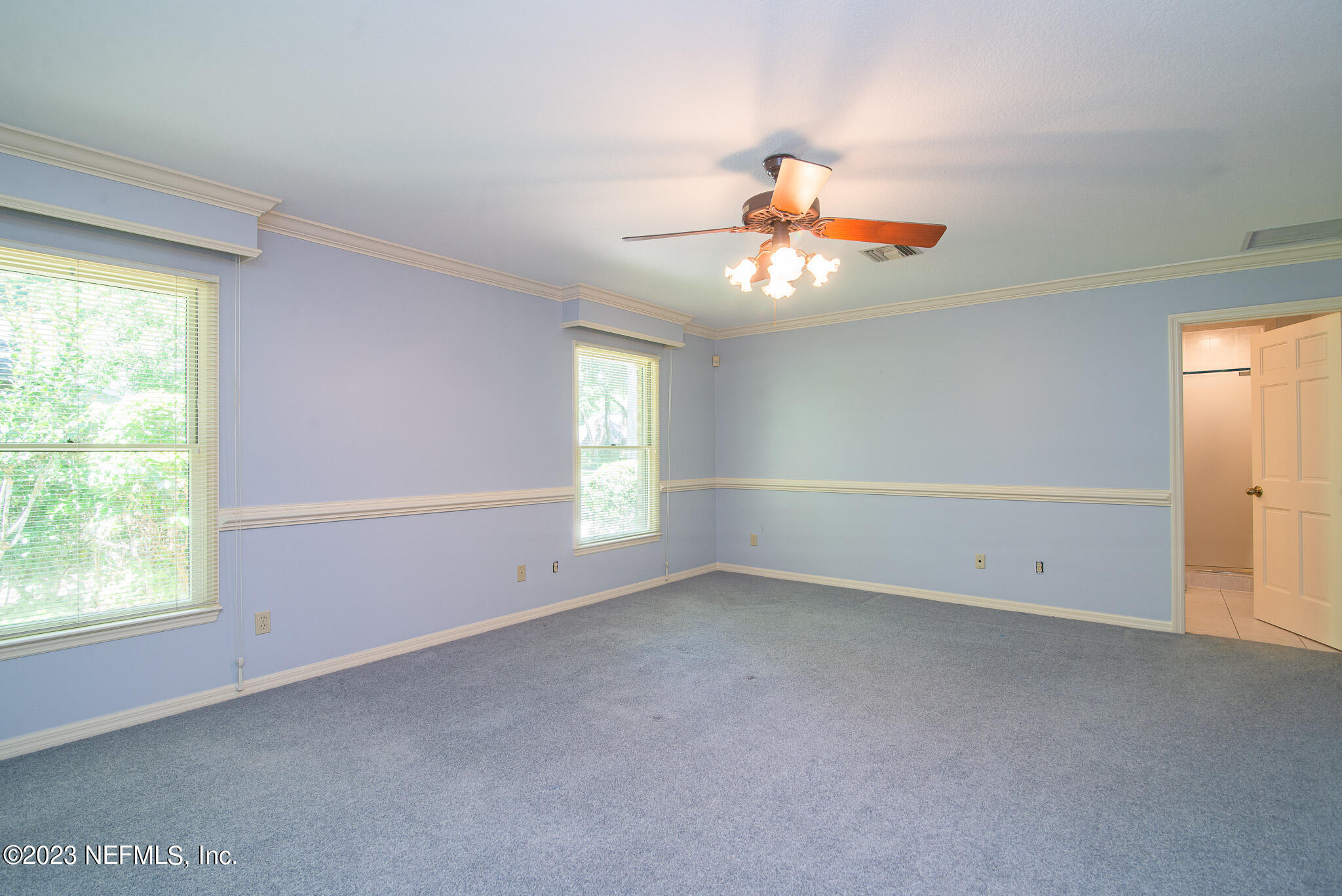 4233 Wicks Branch Road St. Augustine, FL 32086 - Photo 23 of 45 an empty room with windows and chandelier fan