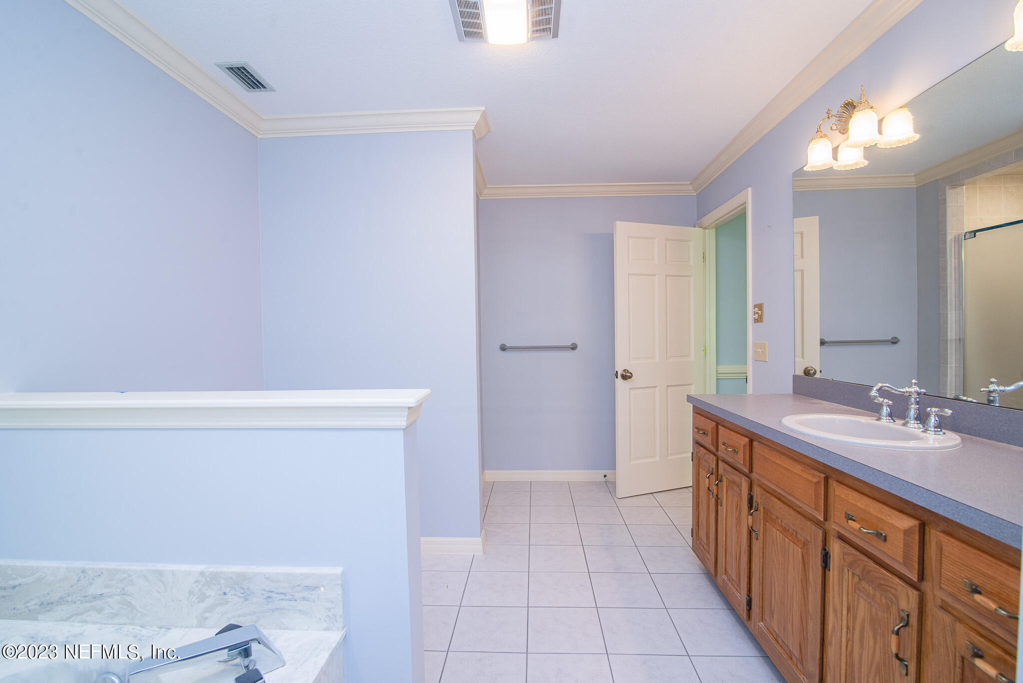4233 Wicks Branch Road St. Augustine, FL 32086 - Photo 27 of 45 a bathroom with a double vanity sink and a mirror