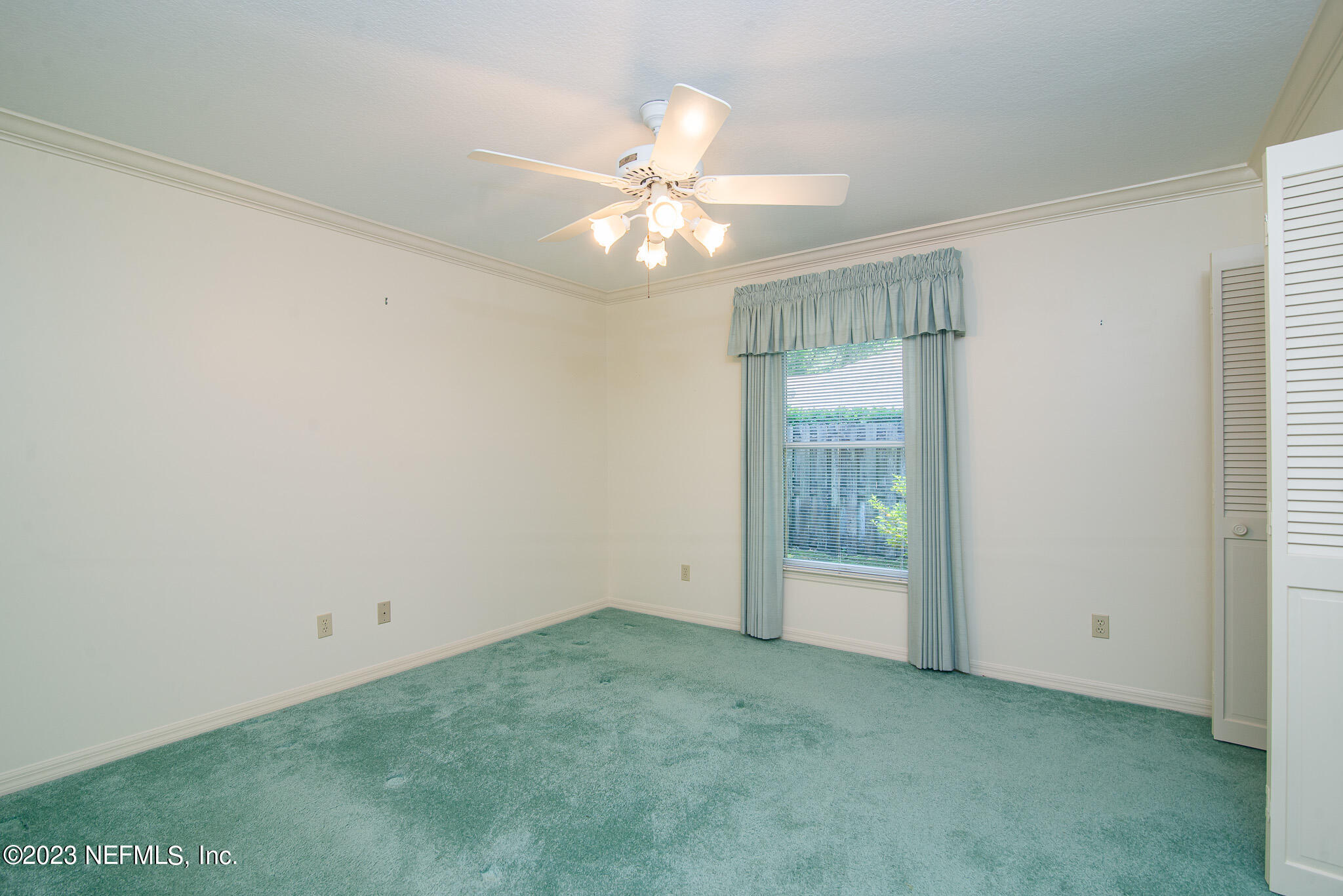 4233 Wicks Branch Road St. Augustine, FL 32086 - Photo 29 of 45 an empty room with a window and a fan