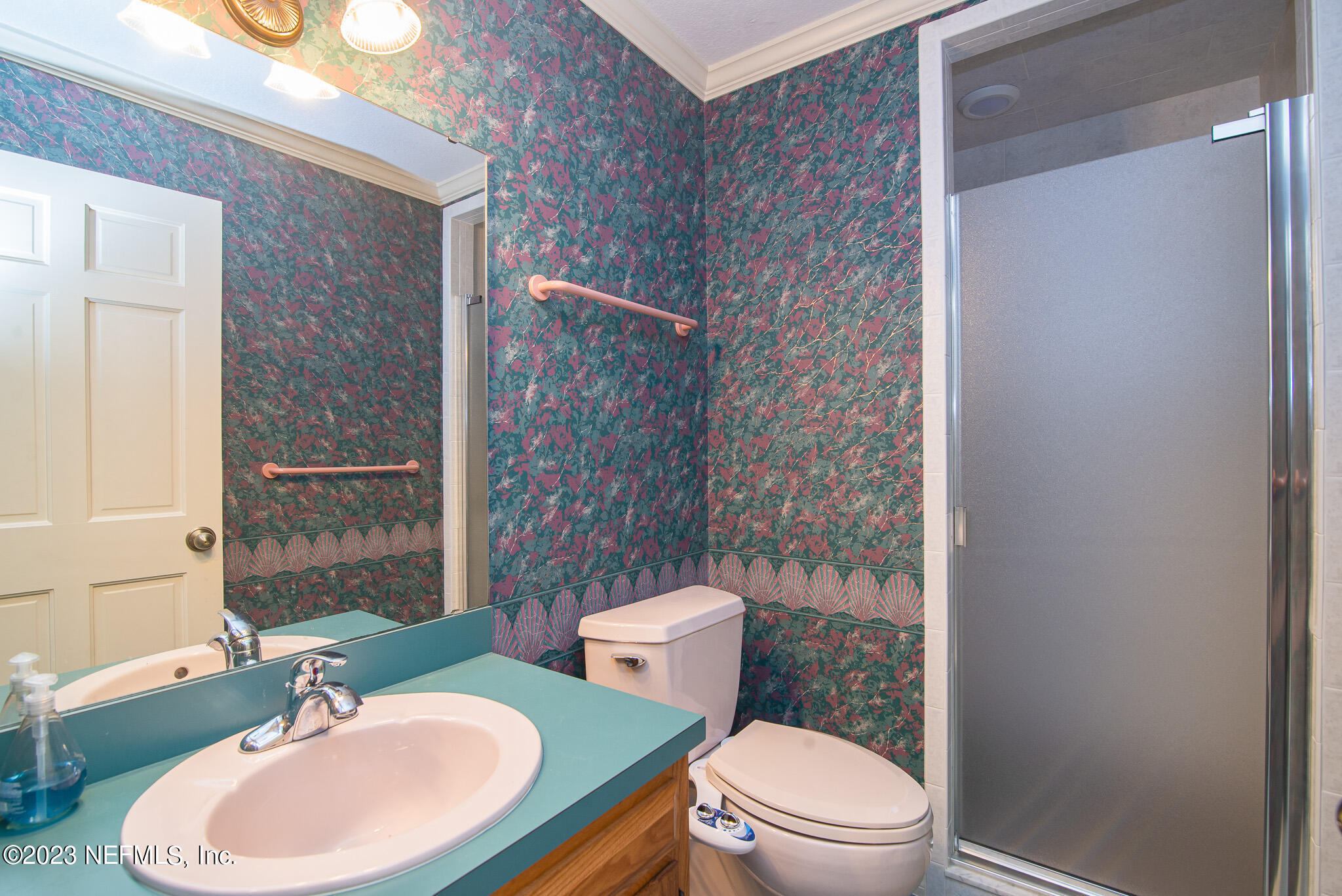 4233 Wicks Branch Road St. Augustine, FL 32086 - Photo 30 of 45 a bathroom with a sink a toilet and shower curtain