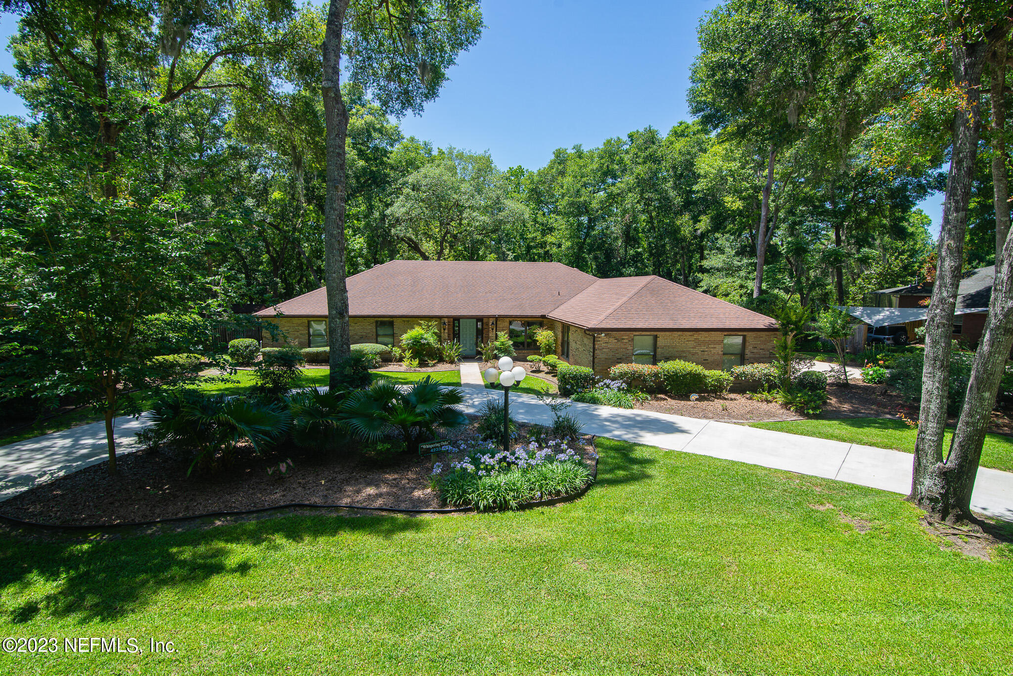 4233 Wicks Branch Road St. Augustine, FL 32086 - Photo 3 of 45 a view of a house with a yard and sitting area