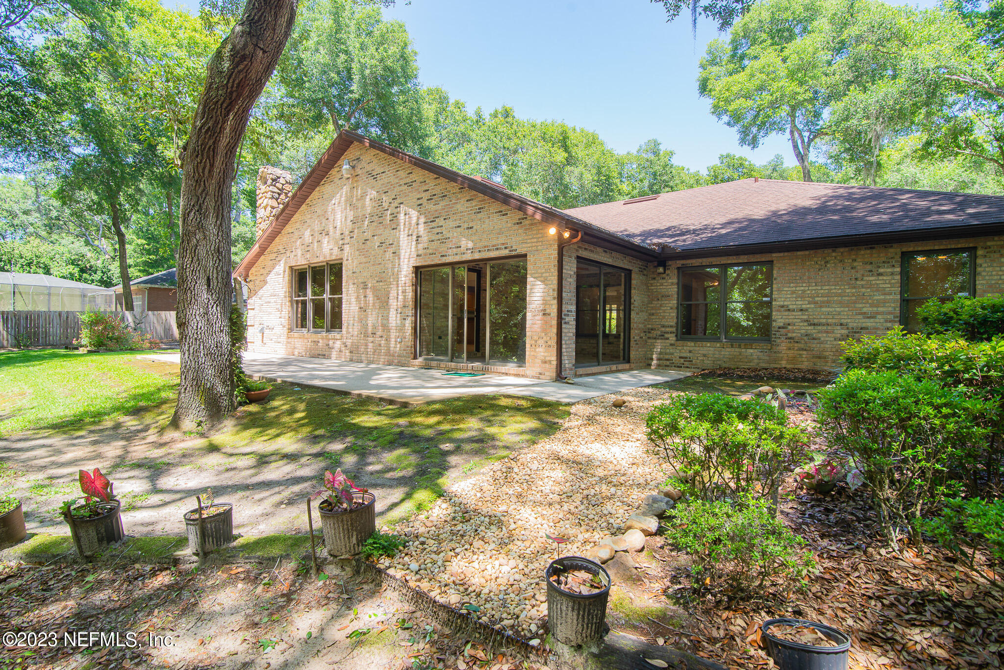 4233 Wicks Branch Road St. Augustine, FL 32086 - Photo 39 of 45 a view of a house with backyard and sitting area