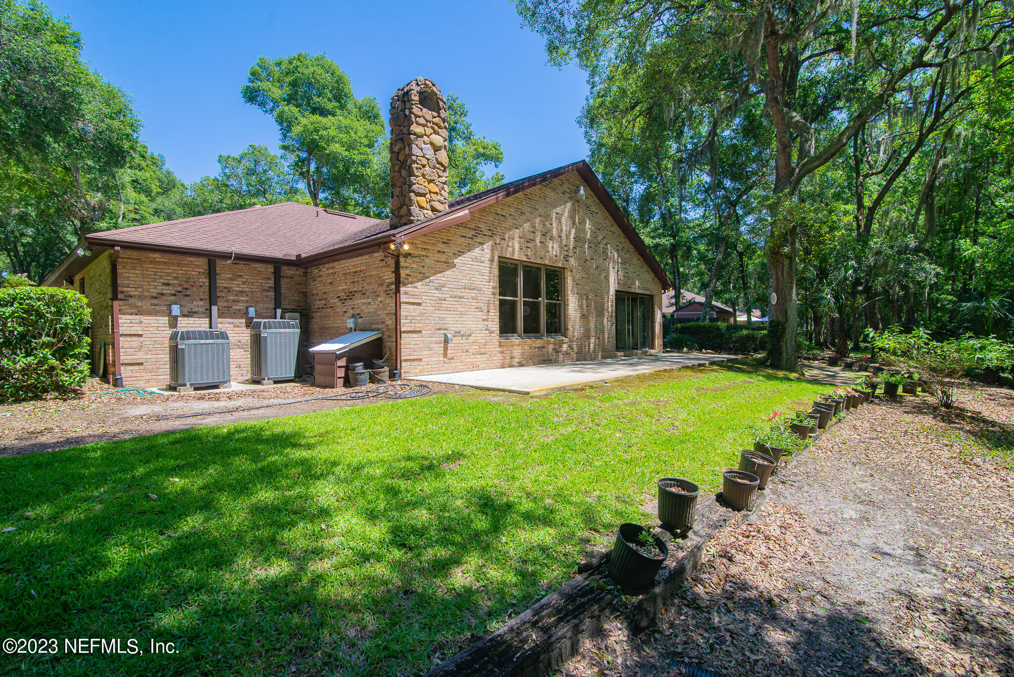 4233 Wicks Branch Road St. Augustine, FL 32086 - Photo 40 of 45 a view of a house with backyard porch and garden