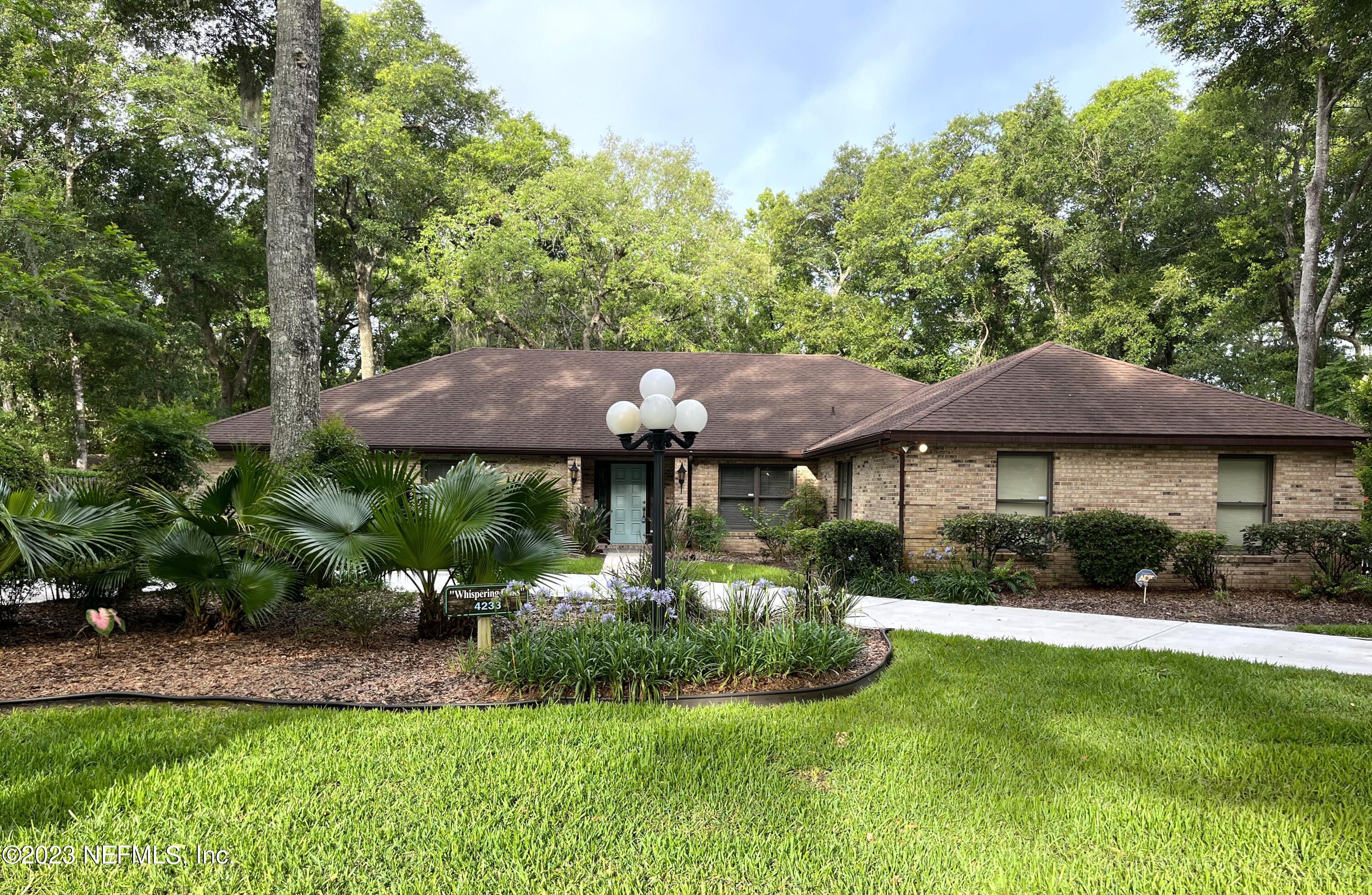 4233 Wicks Branch Road St. Augustine, FL 32086 - Photo 45 of 45 a front view of a house with a yard
