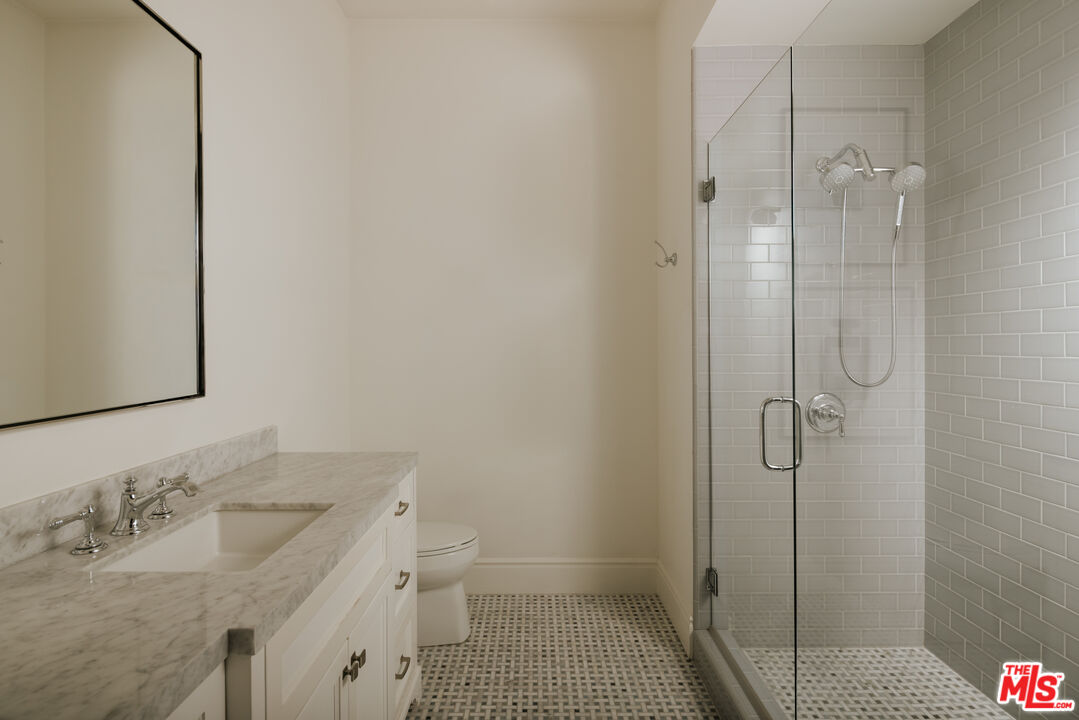 24155 Hidden Ridge Road Hidden Hills, CA 91302 - Photo 14 of 23 a bathroom with a sink toilet and shower