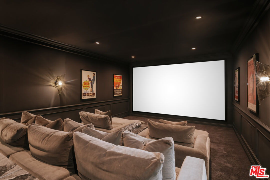 24155 Hidden Ridge Road Hidden Hills, CA 91302 - Photo 17 of 23 a projector room with furniture a projector and screen