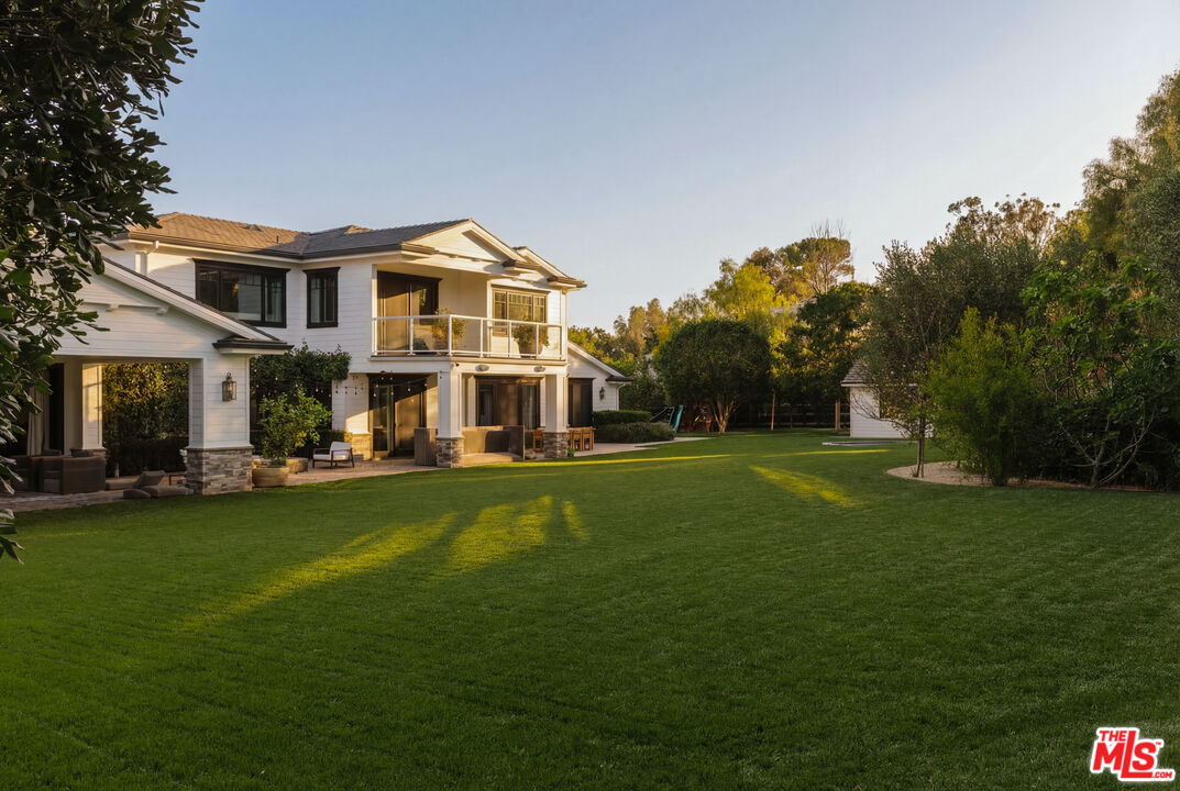 24155 Hidden Ridge Road Hidden Hills, CA 91302 - Photo 23 of 23 a front view of a house with a garden and trees