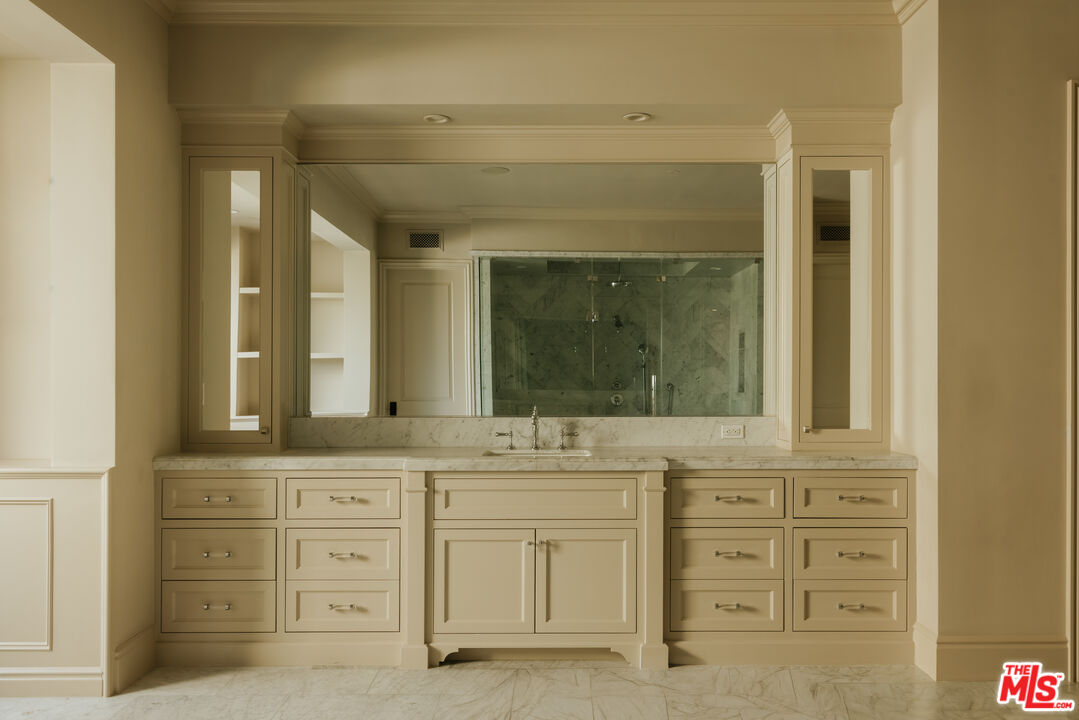 24155 Hidden Ridge Road Hidden Hills, CA 91302 - Photo 10 of 23 a bathroom with a sink vanity and mirror
