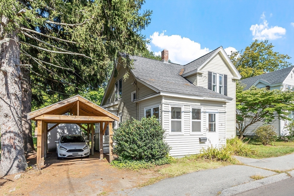 33 West Meadow Road Lowell, MA 01854 - Photo 2 of 36 a front view of a house with a yard