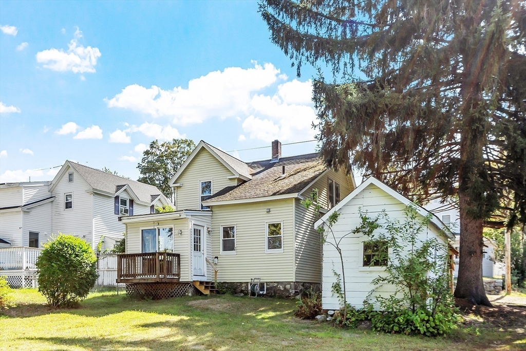 33 West Meadow Road Lowell, MA 01854 - Photo 5 of 36 a view of a white house with a big yard and large trees