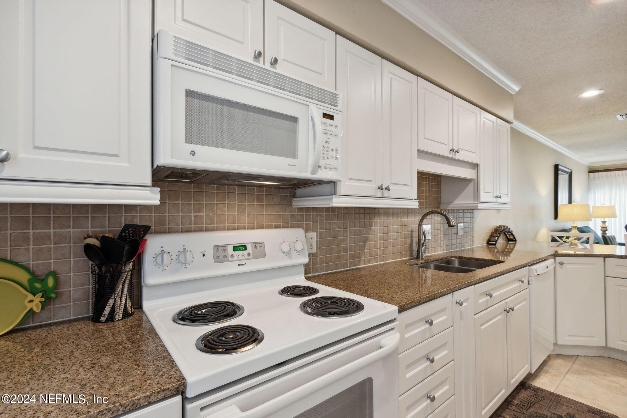 3327 Sea Marsh Road Fernandina Beach, FL 32034 - Photo 6 of 39 a kitchen with white cabinets and white appliances