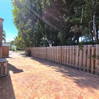 a view of a backyard with wooden fence