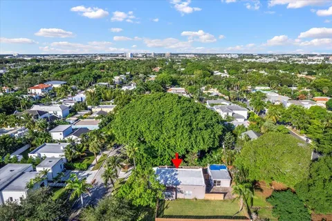 an aerial view of a houses with a yard