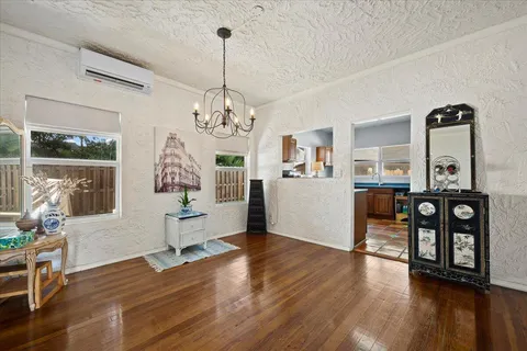 a view of a livingroom with furniture wooden floor a chandelier