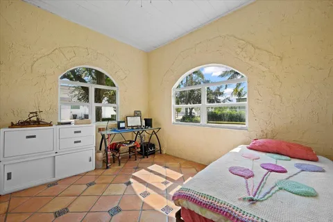 a view of a bedroom with furniture and windows