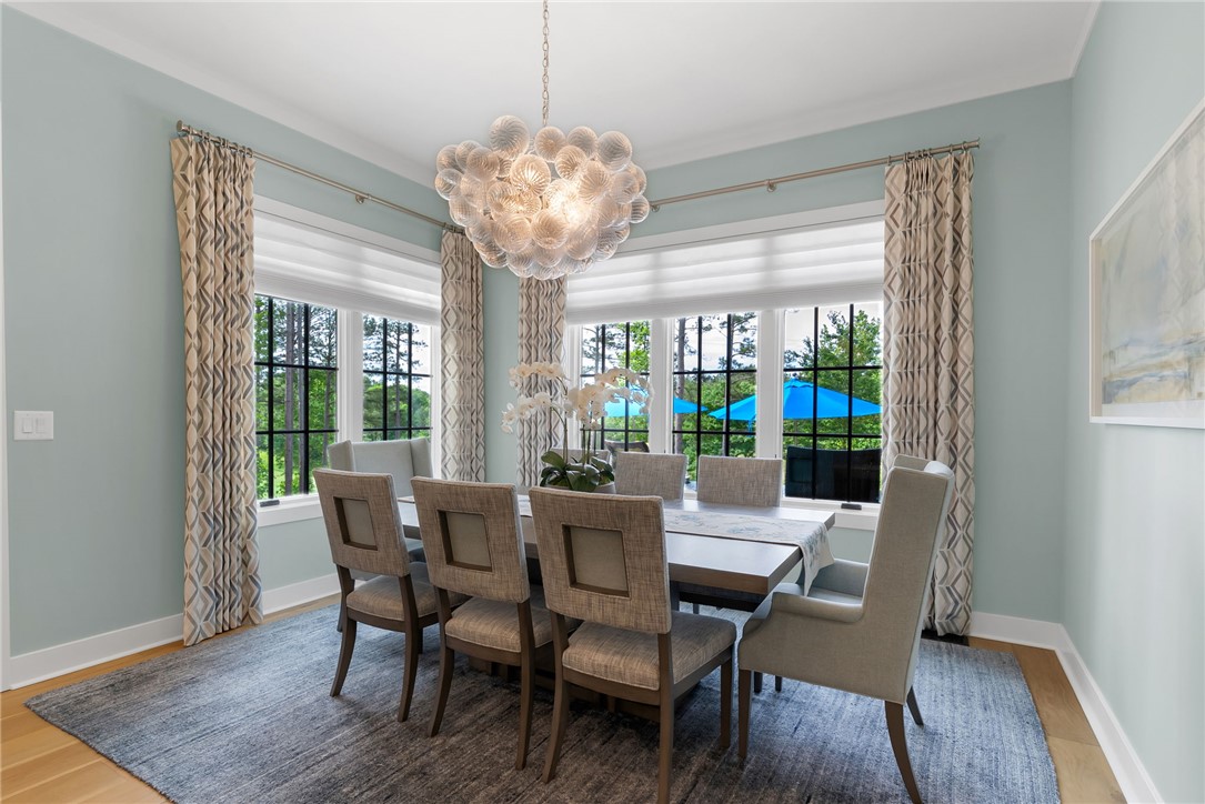 119 Drewberry Lane Sunset, SC 29685 - Photo 9 of 42 This bright dining room features a distinctive chandelier, large windows, and hardwood floors.