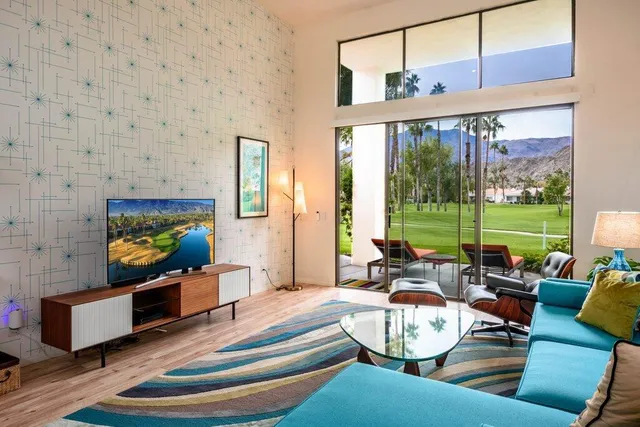 a patio with table and chairs and potted plants