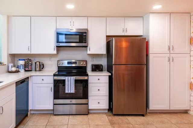 a bedroom with a bed and a lamp