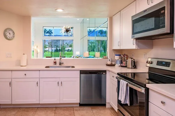 a kitchen with a sink stove and microwave