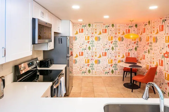 a kitchen with cabinets appliances and a sink