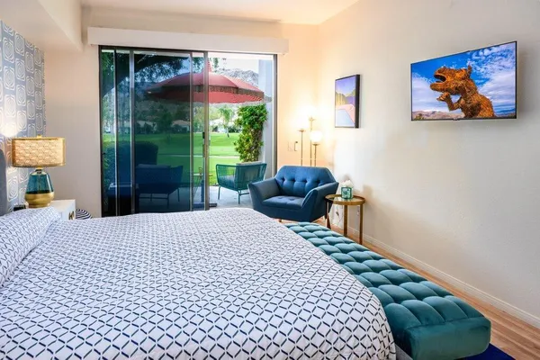 a bedroom with a bed and a painting on the wall